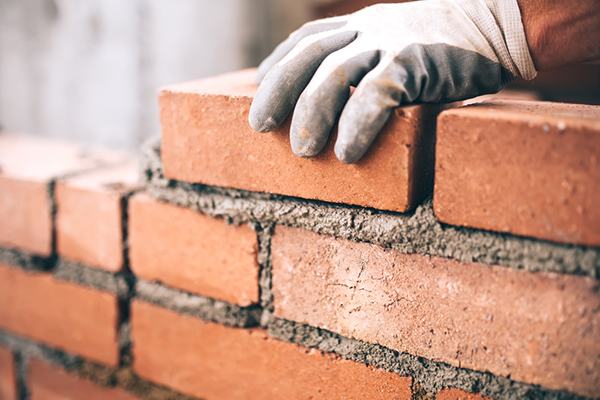 Bricklayer building a wall